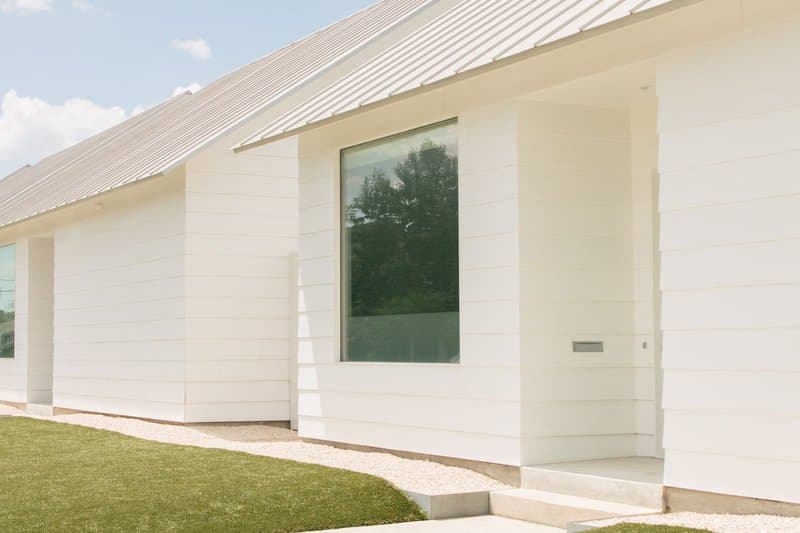 A large fixed picture window on a modern white house in Houston